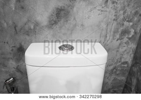 Close Up On A Flush Toilet Button For Cleaning A Toilet.