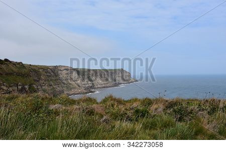 Lovely Scenic View Of The Rugged Sea Cliffs Near Whitby Strand.
