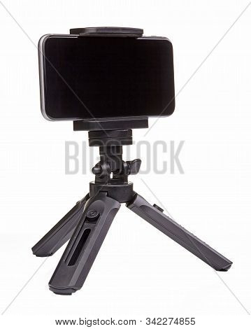 Small Black Tripod For Smartphone Isolated On White Background. Close Up.