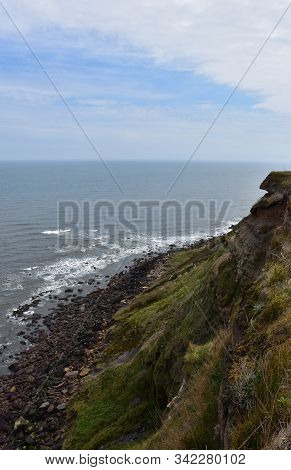 Eroding Sea Cliffs Along The Ocean In Robin Hoods Bay