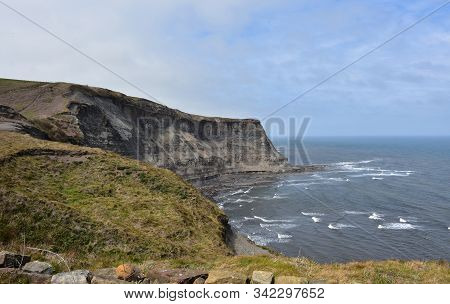 Waves Crashing Ashore In Robin Hood's Bay In England