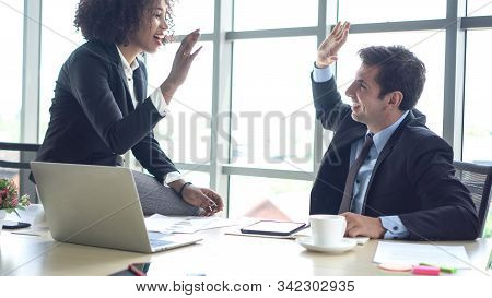 Hispanic And African Interracial Colleague High Five Congratulate Work