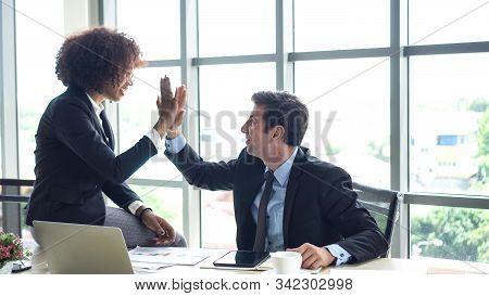 Hispanic And African Interracial Colleague High Five Congratulate Work