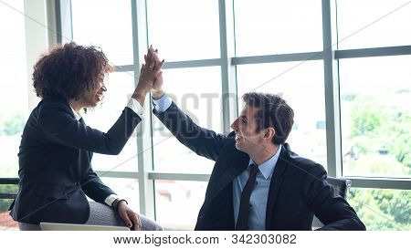 Hispanic And African Interracial Colleague High Five Congratulate Work