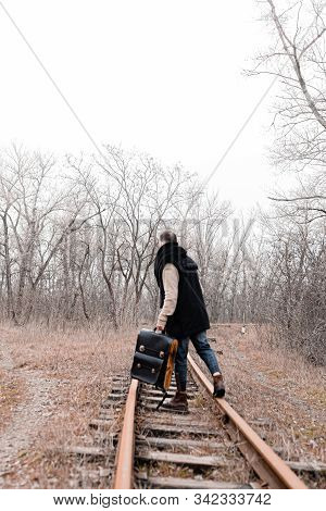 A Man On The Railway Steps On A Journey From Hustle And Bustle. Stock Photo.