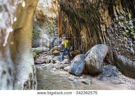 Tourist in Avakas Gorge. Paphos District, Cyprus. Famous small canyon in Sounh Cyprus.