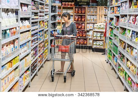 Series Of Asian Woman Shopping Groceries In Modern Supermarket.