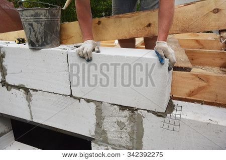 Bricklayer Builder Laying Autoclaved Aerated Concrete Blocks, Aac For New House Wall.
