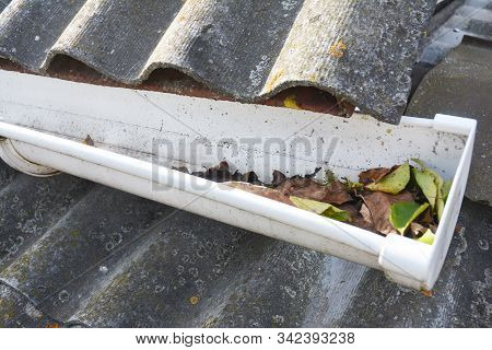 Cleaning Rain Gutters From Leaves. Roof Gutter Cleaning Tips. Gutter Cleaning.