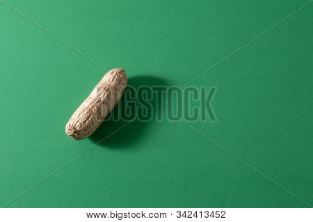 Peanut Pattern Design Concept. Inshell Nuts On A Green Colour Background. Top View. Close Up. Flat L