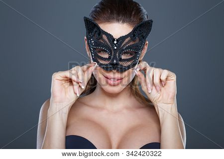 Sexy Brunette Woman Curling Mustache In Catwoman Mask Portrait