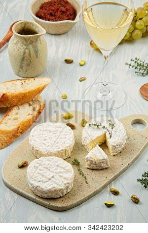 French Cheese Plate And A Glass Of Wine For Buffet Party. Traditional French Or Italian Entires
