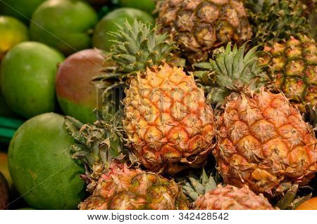 Exotic Fruits, Fresh Ripe Sweet Pinapples And Mango, Tropical Food Background Close Up