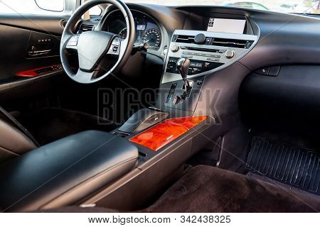 Interior View With Steeering Wheel And Dashboard Of Luxury Very Expensive New White Car Stands In Th
