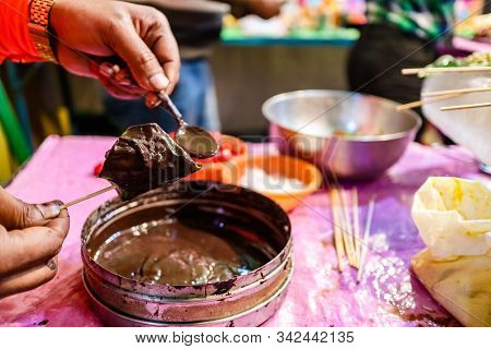 Cone Of Mango Flavored Betel Leaf Stuffed With Cherry Known As Mango Paan.