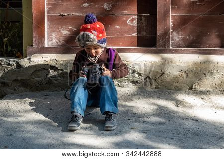 Young Boy Playing With Camera
