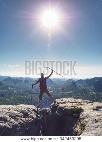 Traveler With Backpack Finnaly Raised Arms With Trekking Sticks Above His Head As Triumph Gesture. P