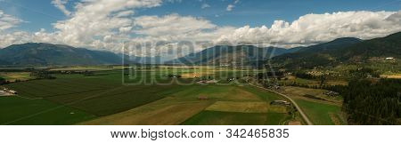 Aerial Panoramic View Of Small Town, Creston, During A Sunny And Cloudy Summer Day. Located In The I