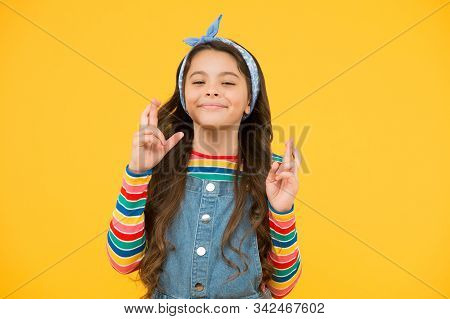 Little Girl Praying. Retro Girl Crossed Fingers. Please. Wait Impatiently. Little Child Yellow Wall.