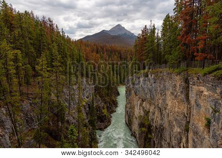 Glacier River Flowing In The Beautiful Canadian Rockies During A Sunny Summer Day. Taken In Sunwapta