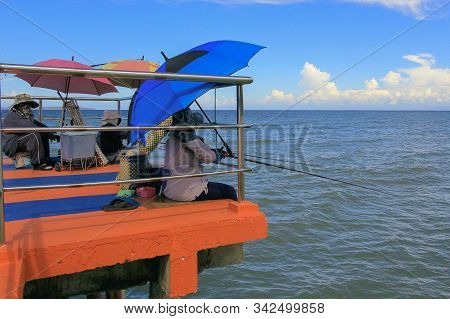 Kuala Penyu,sabah,malaysia-dec 21,2019:traditional Fisherman Enjoying Fishing At Jetty,waiting For F