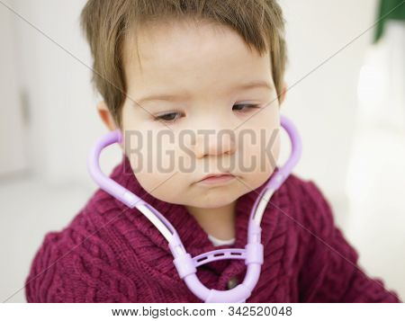 Childrens And Phonendoscope. Little Kid Boy With Phonendoscope Playing Doctor. Healthcare And Medici