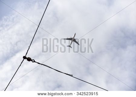Blue Sky With The Wiring Of The Popular Lisbon Trams And Plane In The Background Out Of Focus. Touri