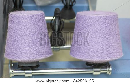 Two Babin Lilac Threads On A Modern Machine For Twisting Threads In Production.