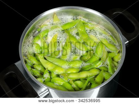 Edamame, Green Soybeans, Maodou, Boiling In Saltwater In A Metal Pot. Soy Beans, Glycine Max., A Leg