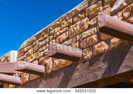 Vigas Protruding From Old Southwestern Stone Building