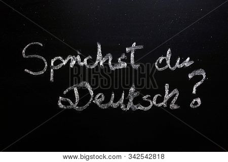 Sprichst Du Deutsch (do You Speak German) Question Written On Chalkboard