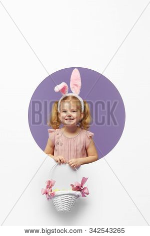 Easter Card. Cute Little Child Girl With Bunny Ears Holding Basket Of Easter Eggs. Child In A Round 