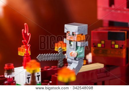 Kiev, Ukraine - December 29, 2019: Minifigure Alex With Sword Running Away From The Magma Cube. Char