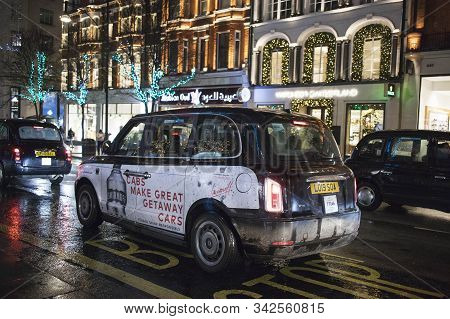 Busy London Street Scene At Oxford Circus With British Flags Decorating Regent Street, A Landmark Re