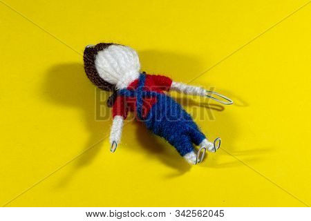 Handmade Crochet Doll Toys On Yellow Background. Amigurumi Doll.