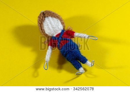 Handmade Crochet Doll Toys On Yellow Background. Amigurumi Doll.