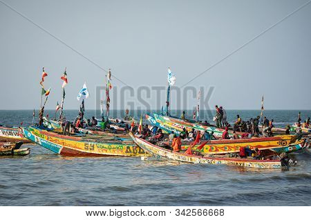 Tanji, The Gambia - November 21, 2019: Scene With Men And Women Carrying Fish From The Boats To The