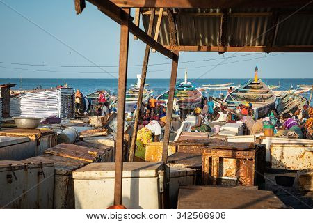 Tanji, The Gambia - November 21, 2019: Scene With Men And Women Carrying Fish From The Boats To The