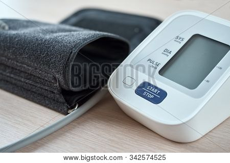 Digital Blood Pressure Monitor On The Table, Closeup. Helathcare And Medical Concept