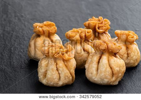 Group  Of Chicken Wontons On Black Stone Background
