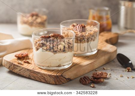 Parfait. Granola Parfait. Delicious Natural Yogurt Parfait With Caramel, Pecan Nuts On Conctere Back