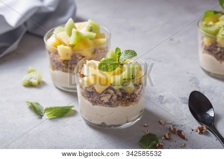 Parfait. Granola Parfait. Homemade Yogurt Parfait With Granola, Kiwi Fruit, Pineapple And Nuts In A 