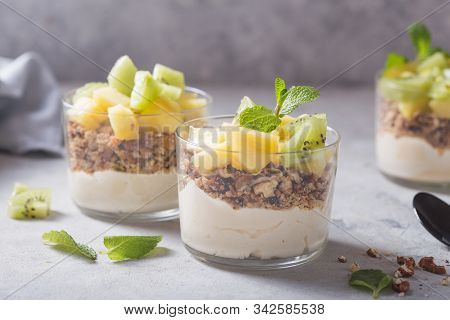 Parfait. Granola Parfait. Homemade Yogurt Parfait With Granola, Kiwi Fruit, Pineapple And Nuts In A 
