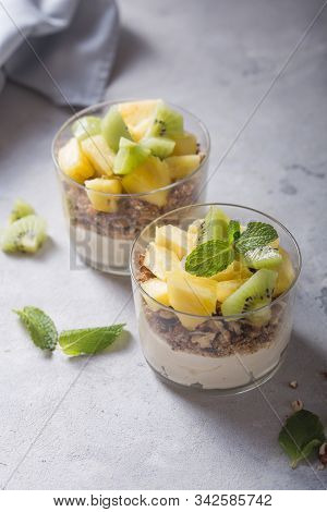 Parfait. Granola Parfait. Homemade Yogurt Parfait With Granola, Kiwi Fruit, Pineapple And Nuts In A 