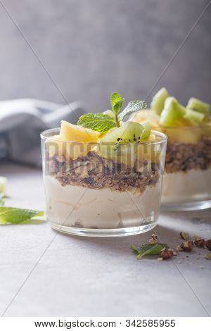 Parfait. Granola Parfait. Homemade Yogurt Parfait With Granola, Kiwi Fruit, Pineapple And Nuts In A 