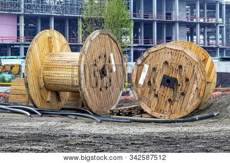 Construction Site With Two Big Empty Cable Drum. Wooden Coil Of Cable Outdoor. Big Empty Wooden Reel