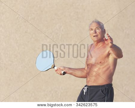 Adult Male Playing Matkot On The Beach