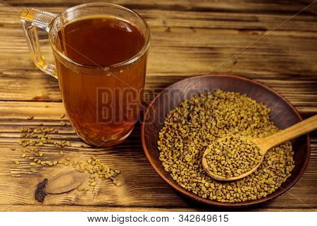 Egyptian Yellow Tea Or Methi Dana Drink And Fenugreek Seeds On Wooden Table