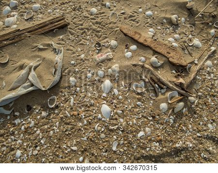 Plastic Debris Bottlecaps Styrofoam Garbage On Beach On A Sunny Winter Day At Sandy Hook, Nj