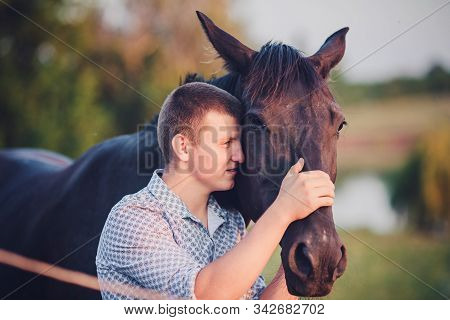 Young Man And A Horse In The Forest